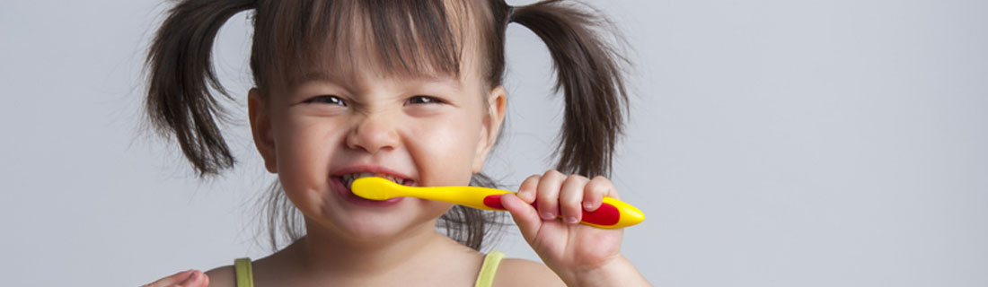 child-brushing-teeth-smiling-pigtails.jpg