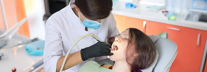 Child receiving dental treatment comfortably with sedation dentistry at pediatric dental clinic. Child receiving dental treatment comfortably with sedation dentistry at pediatric dental clinic.