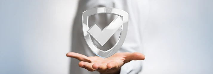 A metalic shield cut out with a checkmark at its center rests atop an outstretched hand indicating insurance is accepted at this dental clinic A metalic shield cut out with a checkmark at its center rests atop an outstretched hand indicating insurance is accepted at this dental clinic