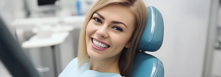 Photorealistic image of a soft brown haired woman giving a wide and toothy smile from the exam chair Photorealistic image of a soft brown haired woman giving a wide and toothy smile from the exam chair