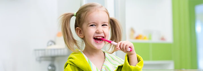 Happy young girl brushing her teeth, promoting dental hygiene and healthy habits for kids. Happy young girl brushing her teeth, promoting dental hygiene and healthy habits for kids.