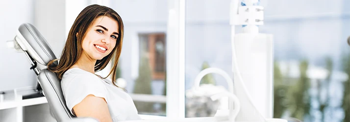 Smiling woman seated comfortably at orthodontic dental clinic. Smiling woman seated comfortably at orthodontic dental clinic.