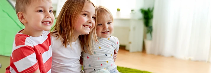 Three smiling children showing healthy teeth after pediatric dental sealant treatments. Three smiling children showing healthy teeth after pediatric dental sealant treatments.