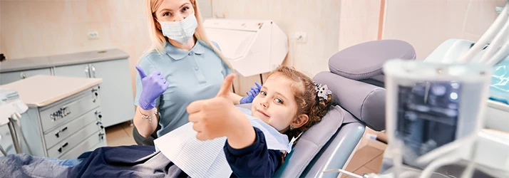 Child receiving pain-free sedation dentistry treatment using nitrous oxide at pediatric dental clinic.