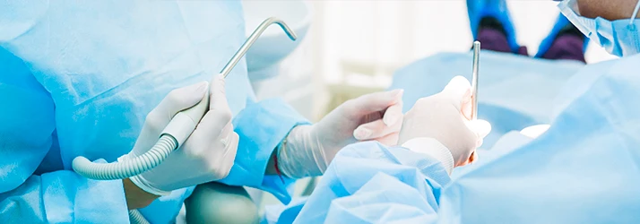 Oral surgeons performing emergency oral surgery procedure. Oral surgeons performing emergency oral surgery procedure.
