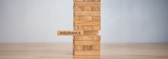 Wooden block labeled "insurance" carefully pulled from Jenga tower, symbolizing dental insurance coverage for oral surgery. Wooden block labeled "insurance" carefully pulled from Jenga tower, symbolizing dental insurance coverage for oral surgery.