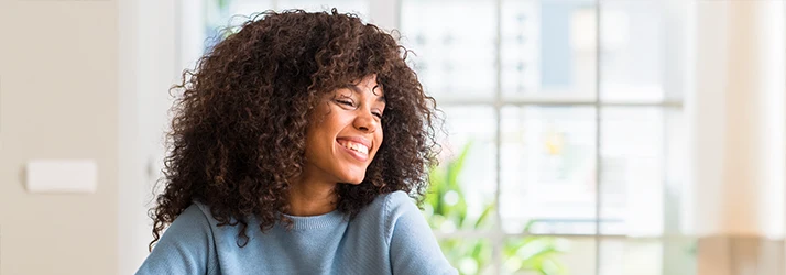 Happy woman smiling confidently after successful orthognathic jaw surgery.