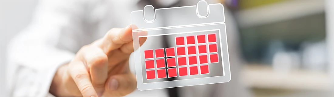 Oral surgeon indicating available dates on a calendar, highlighting ease of scheduling your oral surgery appointment.