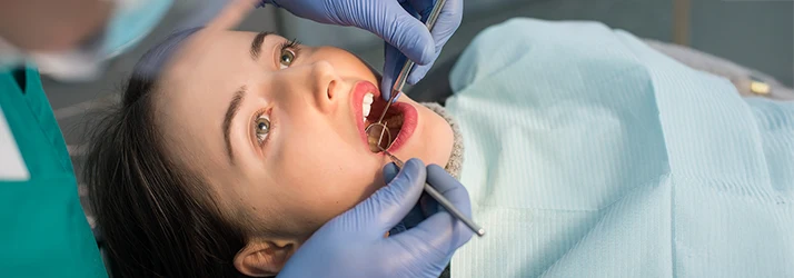 Patient receiving professional gum disease treatment from periodontist. Patient receiving professional gum disease treatment from periodontist.
