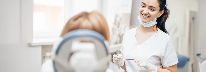 Periodontist discussing non-surgical gum treatment options with patient. Periodontist discussing non-surgical gum treatment options with patient.