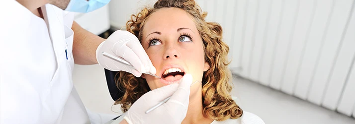 Patient receiving non-surgical periodontal treatment from a periodontist.