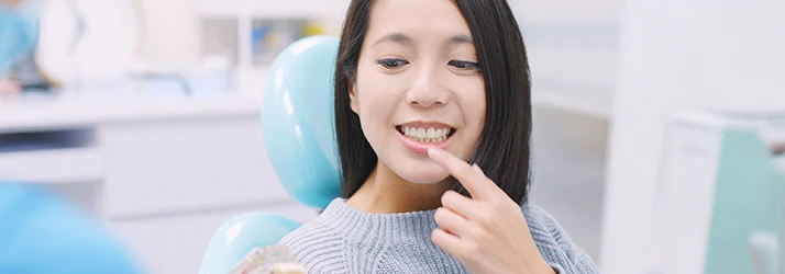 Patient in dental chair discussing osseous surgery and periodontal treatment options with periodontist. Patient in dental chair discussing osseous surgery and periodontal treatment options with periodontist.