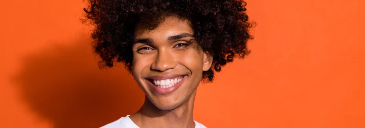 Smiling patient showcasing healthy gums and bright teeth after periodontal treatment. Smiling patient showcasing healthy gums and bright teeth after periodontal treatment.