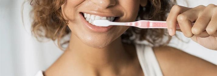 Woman brushing teeth for periodontal preventative care. Woman brushing teeth for periodontal preventative care.