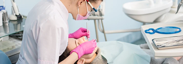 Periodontist performing dental examination and periodontal treatment in a modern dental clinic. Periodontist performing dental examination and periodontal treatment in a modern dental clinic.