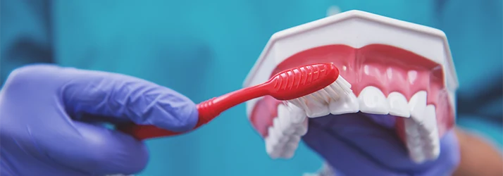 Hand-Brushing-A-Pair-Of-Dentures.webp