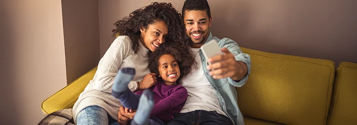 Happy-Family-On-The-Couch-Taking-A-Selfie.webp