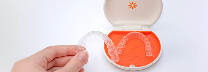 Invisalign-Aligners-And-Their-Orange-Carrying-Tray.webp