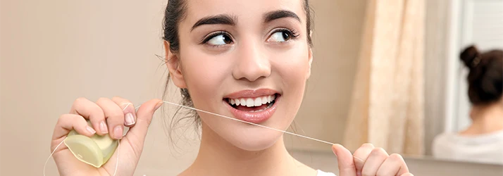 Woman-Flossing-Her-Teeth.webp