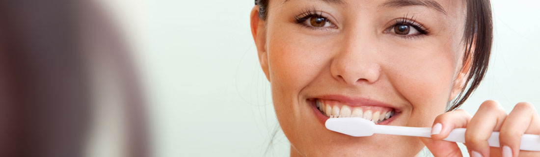 woman-brushing-her-teeth-smiling.jpg