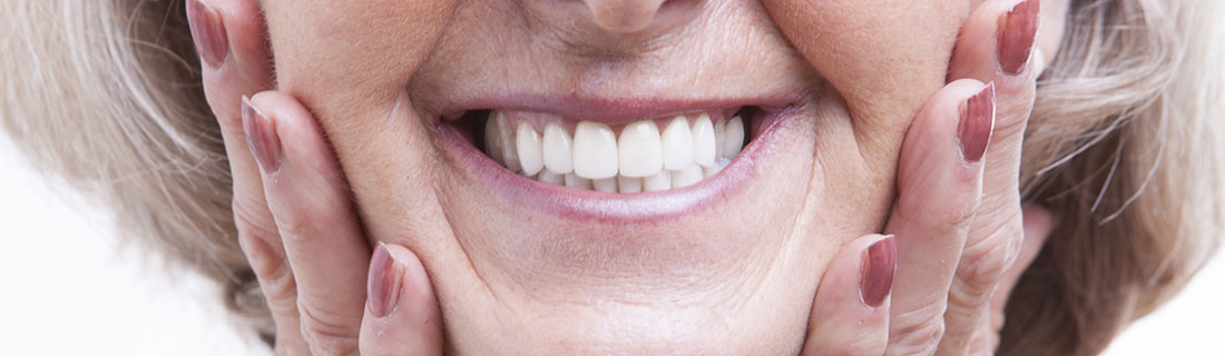 woman-older-dentures-smiling-closeup.jpg